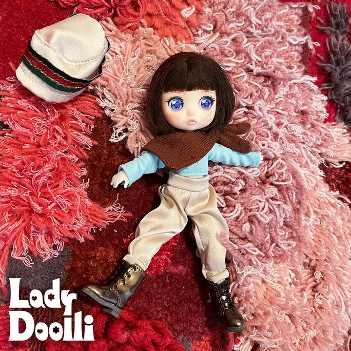 Dark Chocolate in her A Little Tipsy outfit lying on a pink shag rug, bucket hat off to one side